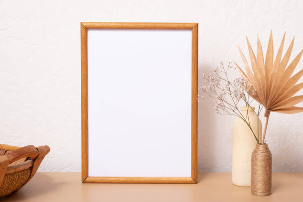 Mock up empty wooden frame mockup, dried leaf and grass in vases on white background, interior, home design. Art concept. copy space. - Photo, image