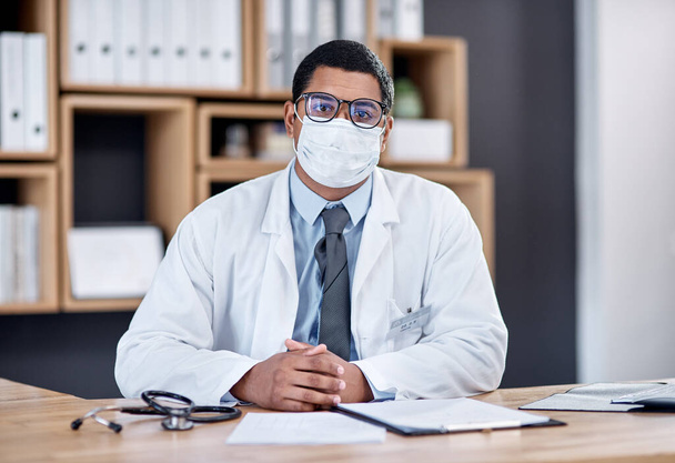 Doctor wearing covid mask in clinic to prevent spread of pandemic virus, disease or illness in hospital consult. Portrait of medical professional, healthcare oe frontline worker ready to treat people. - Foto, Imagem