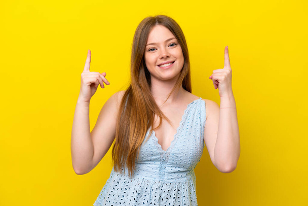 Young caucasian woman isolated on yellow background pointing up a great idea - Photo, Image