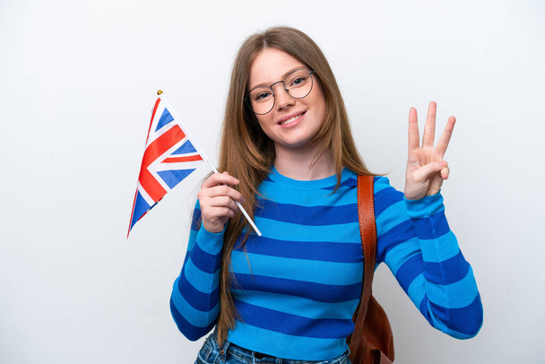 Молода жінка з прапором Сполученого Королівства, ізольована на білому тлі щаслива і рахуючи три пальцями - Фото, зображення