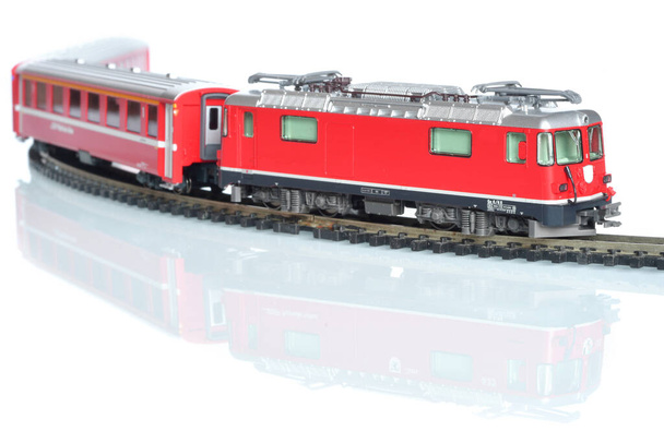 Scale toy model of red train isolated on white reflective background - Fotó, kép