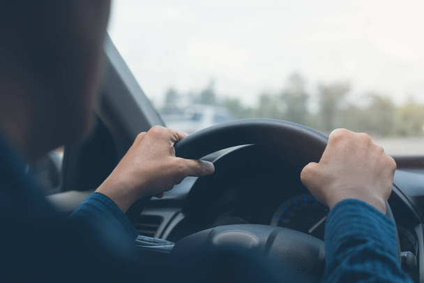 Man holding streering wheel, driving a car in sunny day, close up - Φωτογραφία, εικόνα