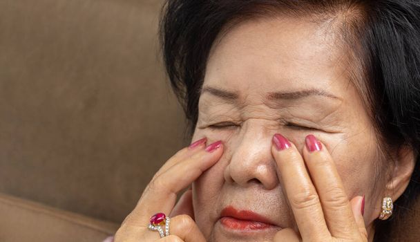 Senior asian woman has eyestrain and fatigue - Fotografie, Obrázek