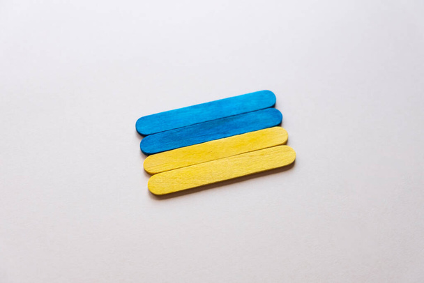 flag of ukraine from wooden sticks on a gray background - Zdjęcie, obraz
