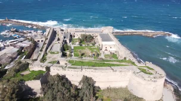 Inside the walls of the historical castle built by the sea, Kyrenia castle taken by drone from the air, Girne protected by the castle walls - Felvétel, videó