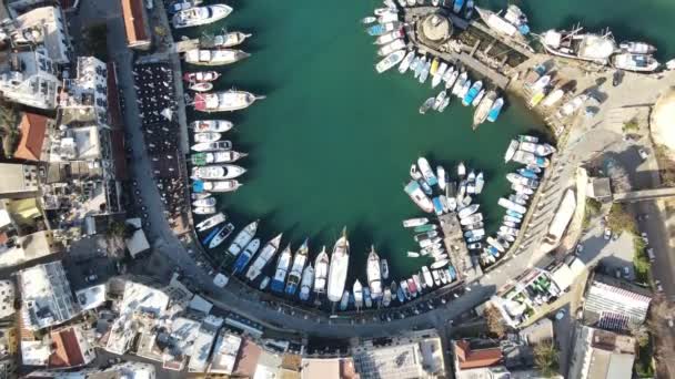 Aerial drone view of Girne marina, harbor where yachts anchor, view of harbor inside the city, beautiful view of the seashore harbor - Felvétel, videó