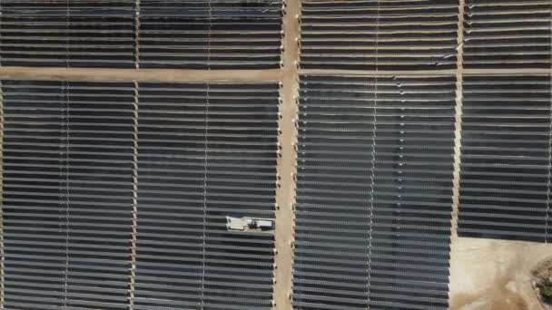 Солнечные батареи, установленные на лесной земле, беспилотный вид на солнечную энергетическую систему в центре суши, генерирующую электрическую энергию для больших стеклянных панелей - Кадры, видео