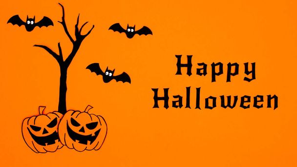 Happy Halloween background with scary tree, pumpkins and bats on orange background. Flat lay minimal concept. Autumn holidays - Φωτογραφία, εικόνα