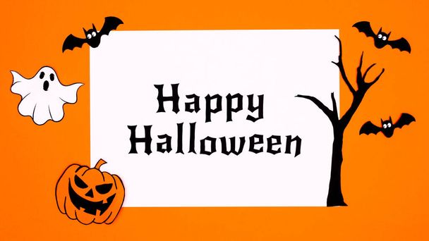 Creative Happy Halloween paper with decoration stickers on orange background. Fall holidays concept. - Photo, image