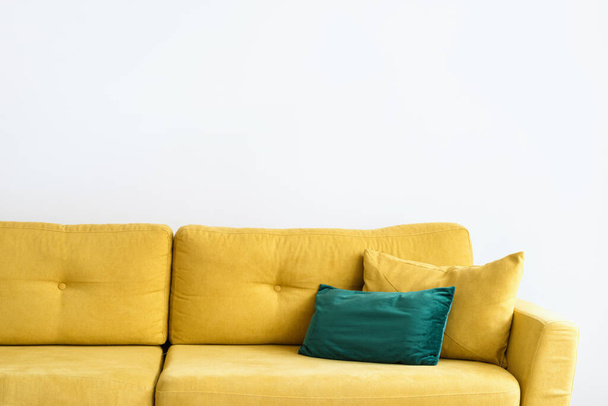 modern velvet couch with bright yellow color upholstery and cushions in living room for comfort rest and relax - Foto, imagen