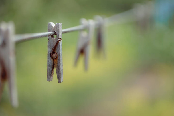 wooden clothespins on rope outdoors, blurred background  - Fotografie, Obrázek