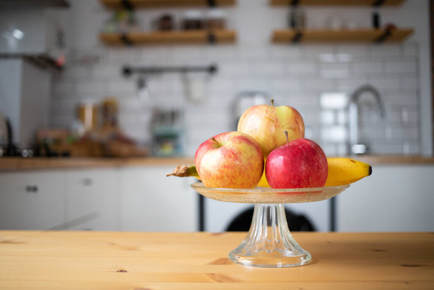 fresh fruit apples and bananas in modern kitchen - Foto, afbeelding