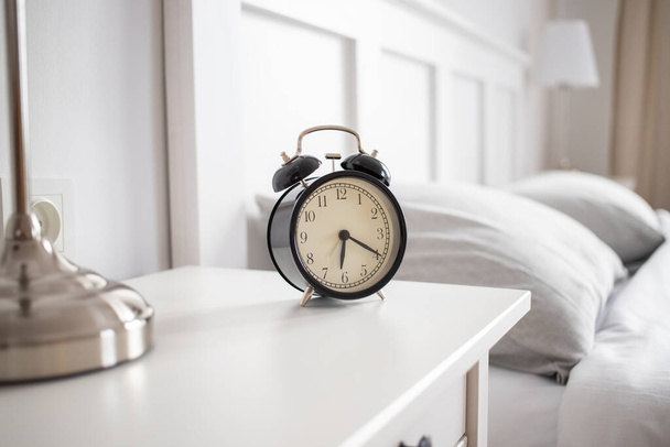 vintage alarm clock in bright bedroom - Photo, Image