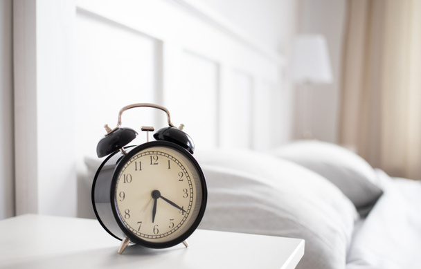 vintage alarm clock in bright bedroom - Fotoğraf, Görsel
