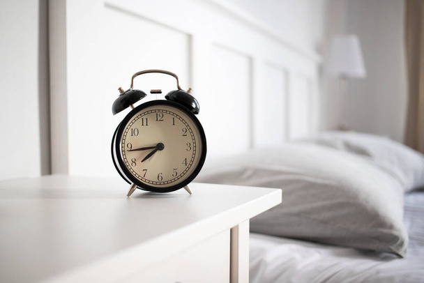 vintage alarm clock in bright bedroom - Fotoğraf, Görsel