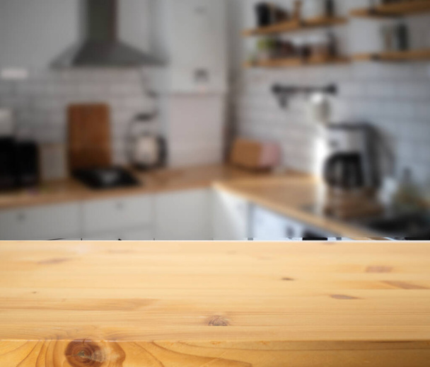 empty wooden tabletop and blurred kitchen mock up for product display - Foto, Imagem