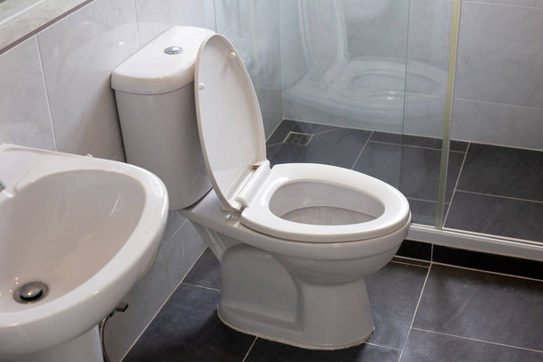 White toilet bowl on floor - Фото, изображение