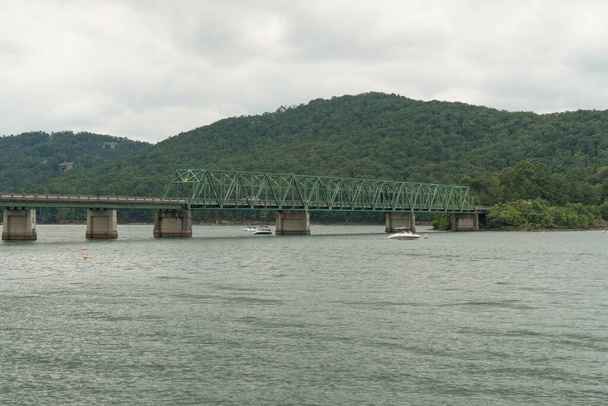 A panoramic view of Bethany bridge over lake Allatoona with locals fishing and pursuing recreational activities in the lake during summer of 2022 - Photo, image