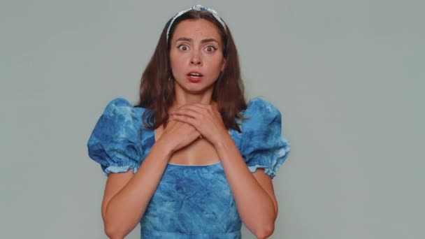 Stressed depressed woman terrified about danger problems, suffering phobia, anxiety disorder, expresses fear, waving no, insecure, stress, panic. Adult girl isolated on gray studio background indoors - Metraje, vídeo