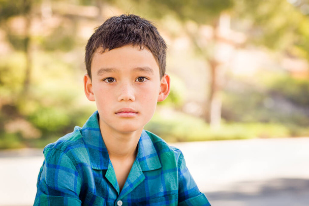 Outdoor portrait of a mixed race Chinese and Caucasian boy. - Photo, image