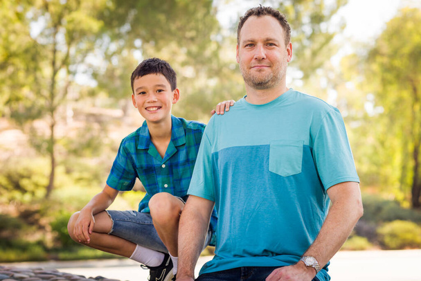 Outdoor portrait of mixed race Chinese and Caucasian father and son. - Photo, image