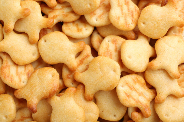 Delicious goldfish crackers as background, closeup view - Zdjęcie, obraz