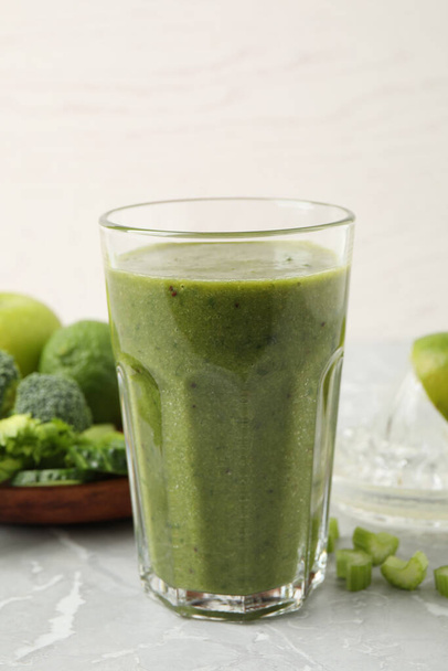 Delicious fresh green juice on grey marble table - Fotografie, Obrázek