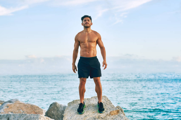 I refuse to settle for average. Portrait of a shirtless and muscular young man standing outdoors - Foto, afbeelding