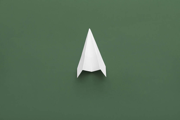 White paper plane on green background - Foto, Imagem