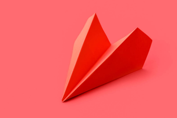 Red paper plane on color background - Foto, Imagen