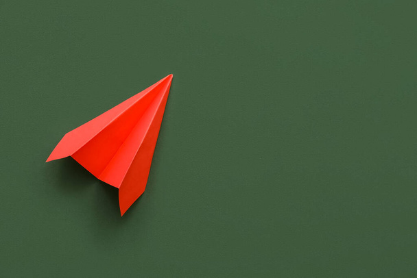 Red paper plane on green background - Zdjęcie, obraz