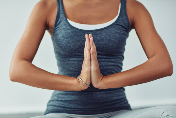 Finding her zen. an unrecognizable woman practicing yoga at home - Fotografie, Obrázek