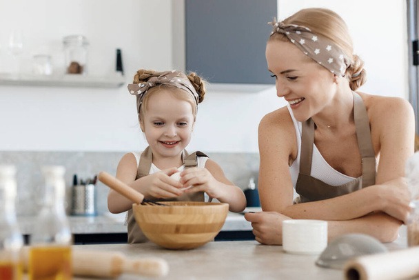 mother and daughter cooking and baking in the kitchen. High-quality photo - Фото, зображення