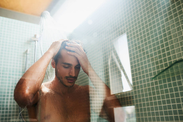 Lets start this day the fresh way. a handsome young man having a refreshing shower at home - Zdjęcie, obraz
