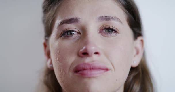 Sadness, depressed and unhappy woman crying in pain, depression and feeling bad over loss and sorrow in a close up portrait. Lady in tears with negative emotion, stressed and upset facial expression. - Záběry, video