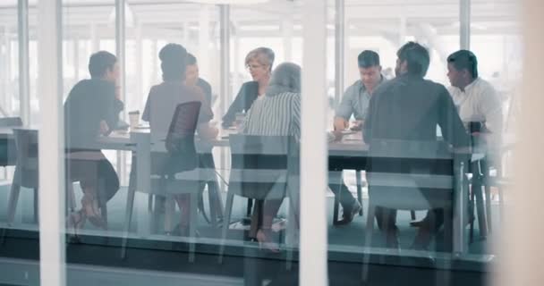 Businesspeople in a boardroom planning new global innovations in a diverse group office meeting together. Corporate executives having an international team discussion about their mission strategy. - Filmmaterial, Video