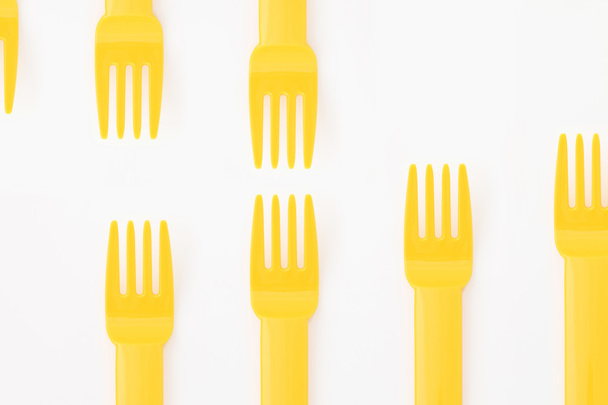Yellow plastic forks - 写真・画像