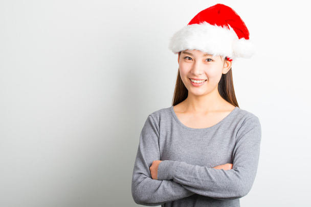 Young asian woman with Christmas hat isolated on white. - Foto, afbeelding