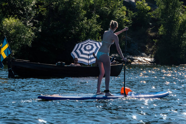 Stockholm, Sweden People riding stand up paddle boards in the summer - Fotografie, Obrázek
