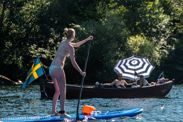 Stockholm, Sweden People riding stand up paddle boards in the summer - Fotografie, Obrázek