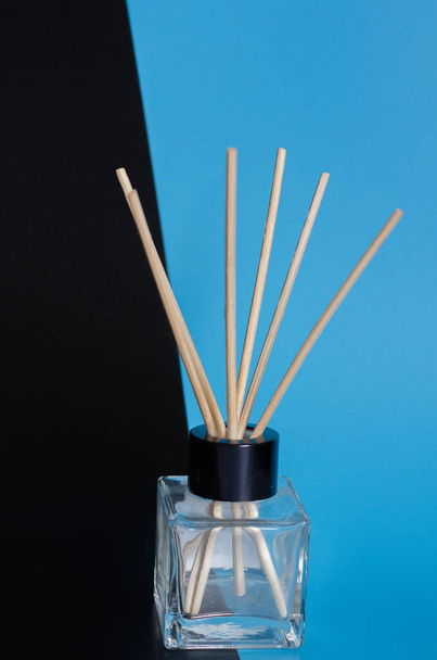 home diffuser with incense sticks on blue and black background - Foto, Imagem