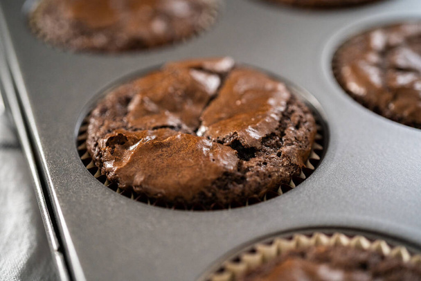 Cooling freshly baked chocolate peppermint cupcakes on a kitchen counter. - Foto, Imagen
