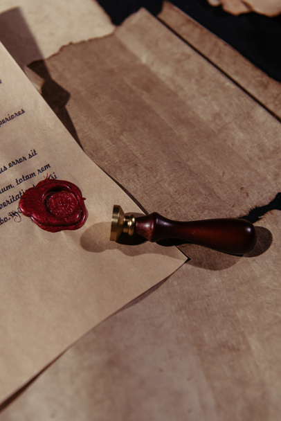 top view of wax seal and old manuscript on craft paper surface - Photo, Image