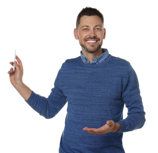 Handsome man pointing at something with pen on white background. Weather forecast reporter - Foto, immagini