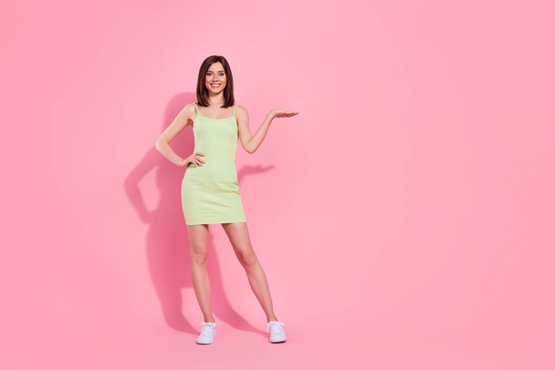 Full length photo of pretty lady arm touch waist palm offer quality summer clothes boutique empty space isolated on pink color background. - Foto, Imagem