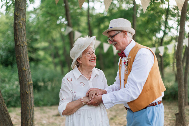 Senior couple having marriage in nature during a summer day. - 写真・画像