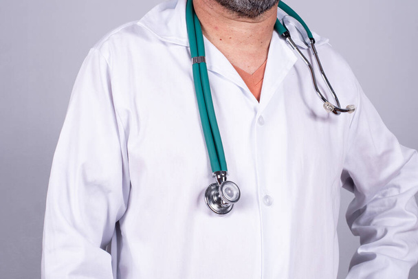 Senior attractive Brazilian doctor in a white coat, no face - Foto, Bild