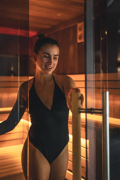 Attractive young woman in a swimsuit in the sauna. - Foto, immagini