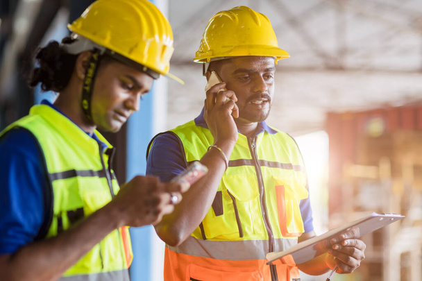 Indian Engineer worker foreman using telephone calling communication and technology device in factory workplace - Φωτογραφία, εικόνα