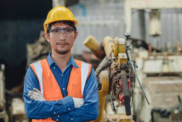 portrait Asian smart engineer male worker standing armcrossed in heavy metal factory happy smile - Foto, Imagem